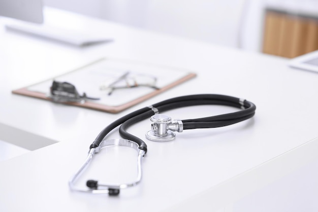 Stethoscope, prescription medical form lying on a table with pc computer. Medicine or pharmacy concept. Medical tools at doctor working table.