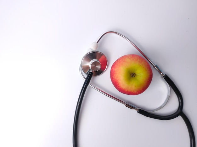 Stethoscope and red apple isolated on a white background Health care and medical concept idea