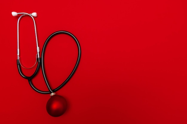 Photo stethoscope red background new year for medical bannercalendar creative in medicine concept