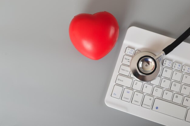 Stethoscope red heart and computer keyboard Online medical consultation concept