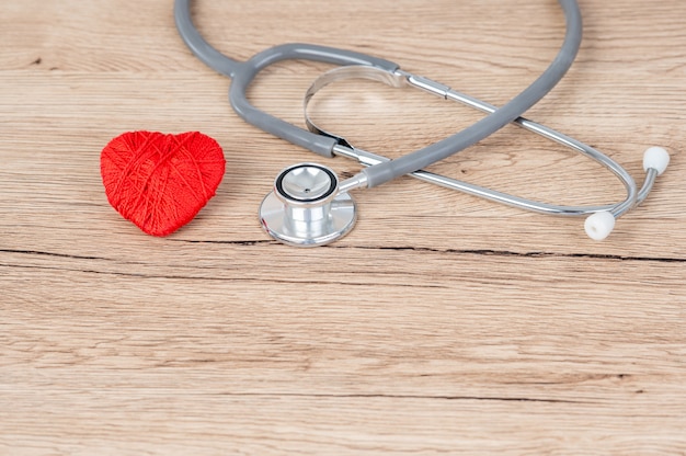 Stethoscope and red heart pace on the desk