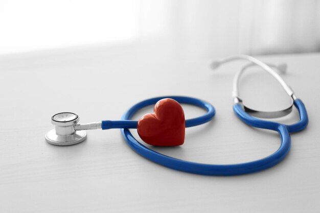 Stethoscope and red heart on table