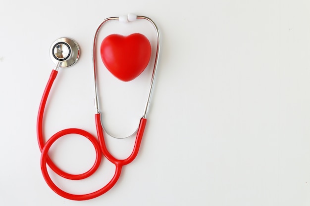 Photo stethoscope and red heart on white