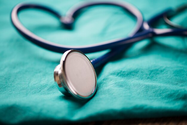 A stethoscope shaping a heart on a medical uniform, closeup