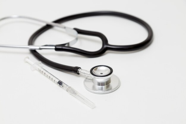 Stethoscope and syringe on table