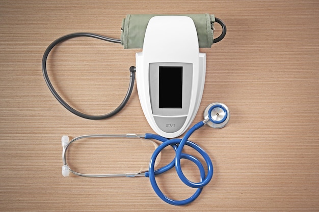 Photo stethoscope and tonometer on wooden table