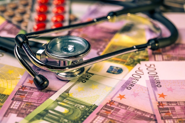 A stethoscope on top of euro banknotes