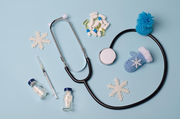 Stethoscope, vaccine,pills on a blue medical background,vaccination during the winter cold period