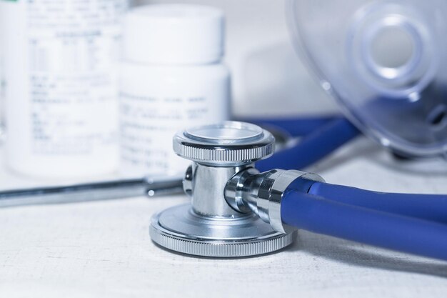 A stethoscope was on the table and there were empty medicine bottles and medical supplies