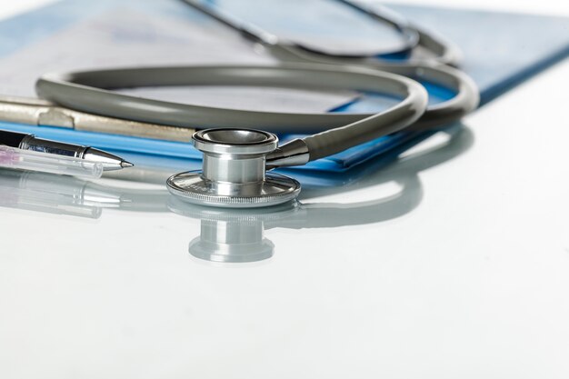 stethoscope with blue medical clipboard
