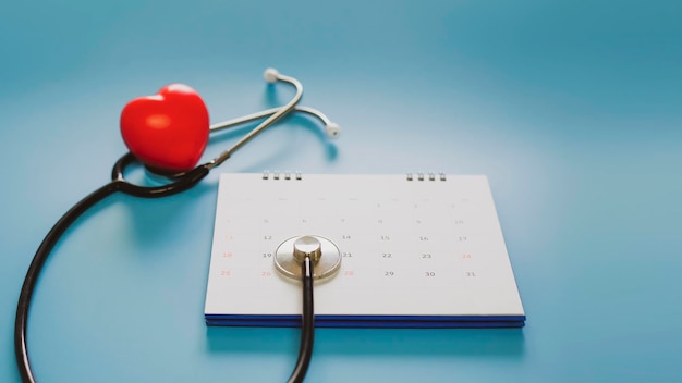 Stethoscope with date on the calendar page on a blue background Health care concept