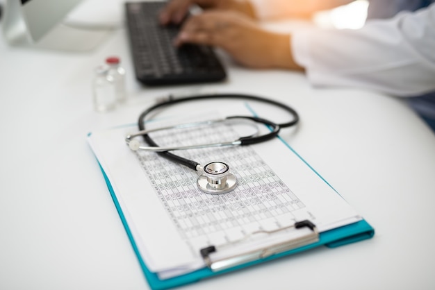 Photo stethoscope with doctor working on desk computer, communication, meeting.