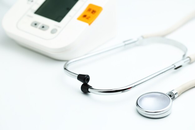 Stethoscope with Electronic Blood Pressure Monitor or Sphygmomanometer on the white background. Healthcare concept.