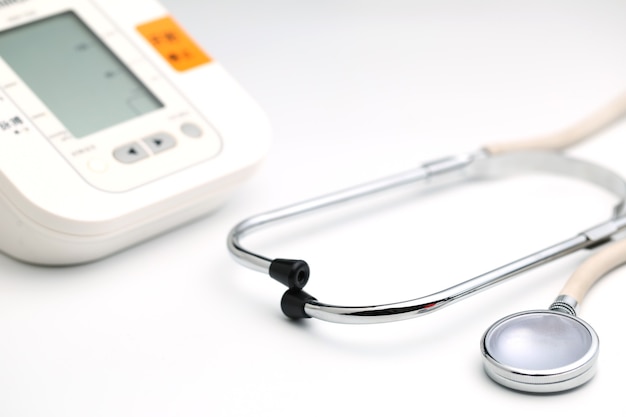 Photo stethoscope with electronic blood pressure monitor or sphygmomanometer on the white background. healthcare concept.