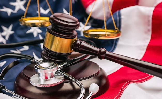 Stethoscope with gavel and scale on a amerian USA flag. ideal for websites and magazines layouts