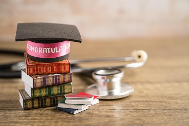 Stethoscope with graduation hat on book with copy space learning university education concept