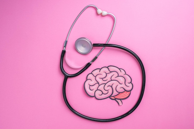 Photo stethoscope with human brain cutout paper health or pathological condition of human brain