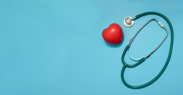 Stethoscope with red heart on blue background Heart diseases Doctors Day  and Medicine concept