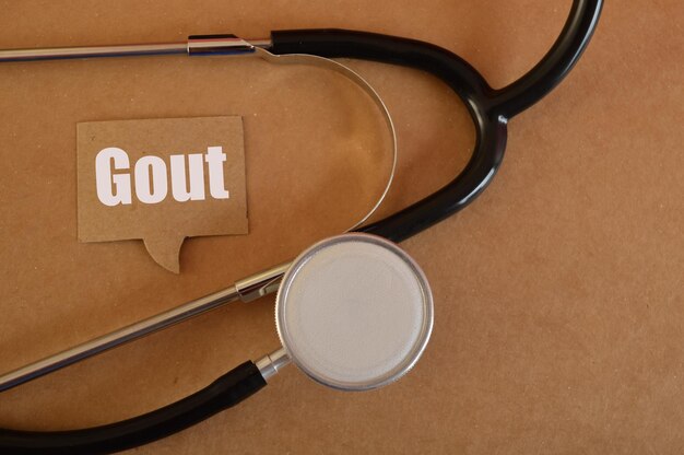 Photo stethoscope with text gout gout is a type of arthritis characterized by sudden and severe attacks of pain redness swelling and tenderness in the joints