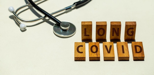 Stethoscope and wooden blocks with wording LONG COVID