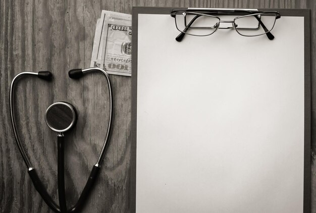 Stethoscope on wooden paper glasses