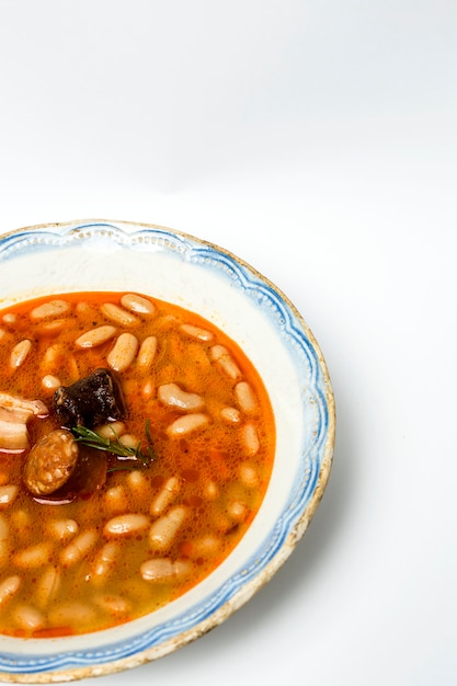 Stew of beans with chorizo and pork.Isolated