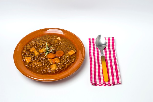 Stew of lentils with chorizo and pork.Isolated