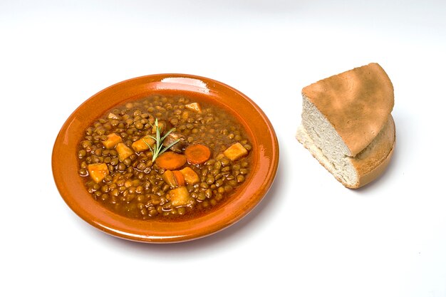 Stew of lentils with chorizo and pork.Isolated