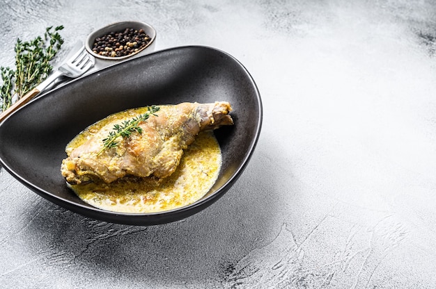 Stew with hare legs with rosemary and garlic. Gray background