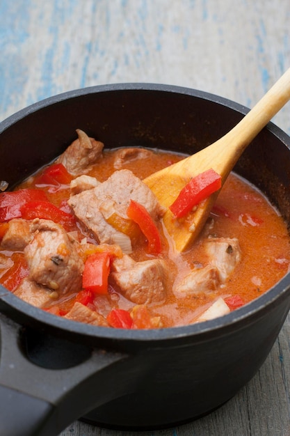 Stew with tomatoes red bell pepper in sauce with spices in a saucepan