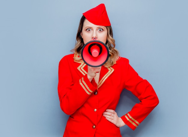 stewardess dragen in rode uniform met megafoon