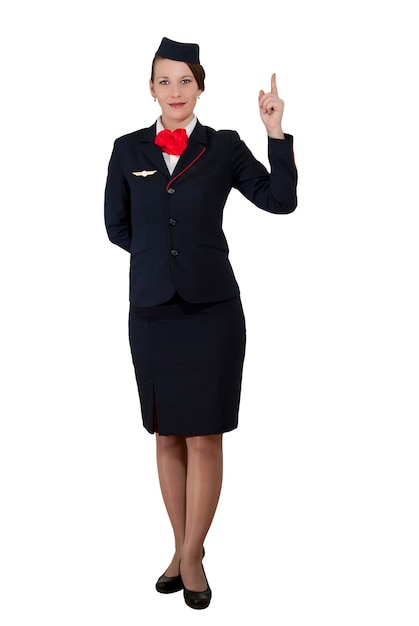 Photo stewardess in full growth on a white background stands and shows the index finger up