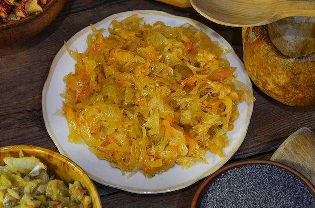 Stewed cabbage with spices on a wooden table Dish with cabbage Braised stew cabbage