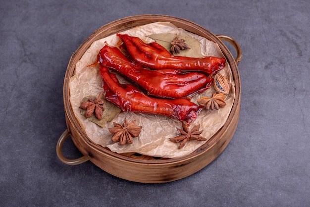 Stewed chicken feet are in the container in the dark background