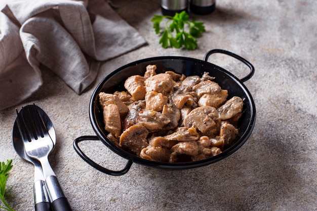 Stewed chicken fillet with mushrooms