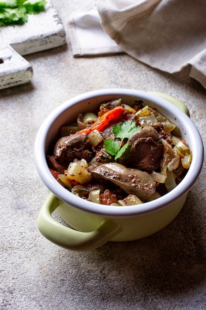 Photo stewed chicken liver with vegetables