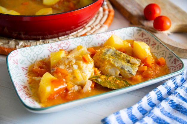 Stewed cod with potatoes and vegetables. Traditional northern Spanish recipe.