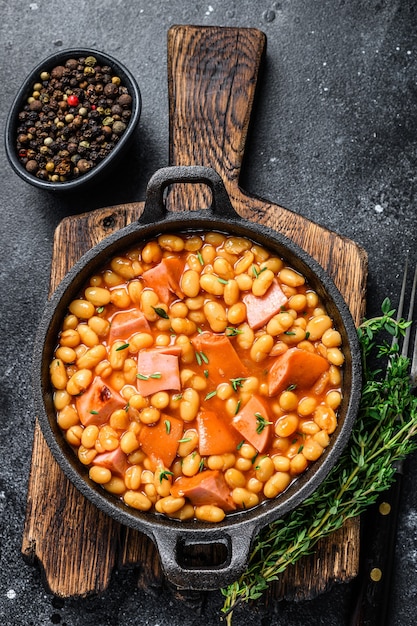 Stewed Kidney beans with smoked sausage and tomato sauce in a pan.