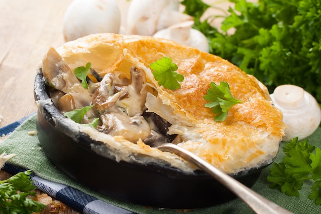 Stewed mushrooms under puff pastry.