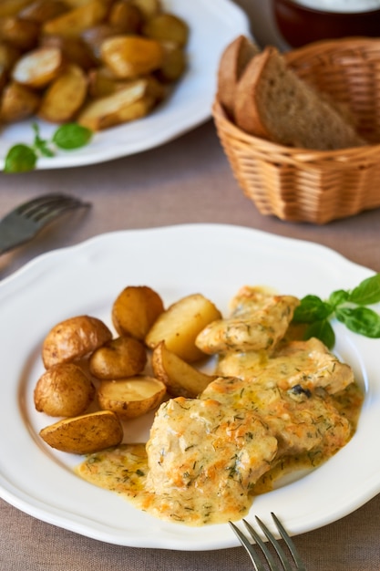 Stewed pork in creamy sauce with baked potatoes