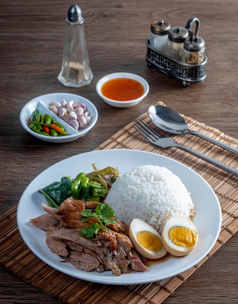 Stewed pork legs with rice on the wooden table