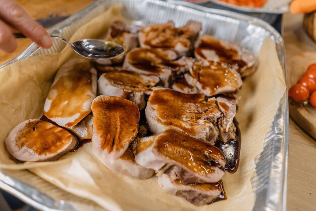 Stewed slices of beef tongue sprinkled with sauce Laid out on a baking sheet kitchen Macro