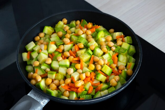 тушеные овощи с кабачками из нута на сковороде крупным планом