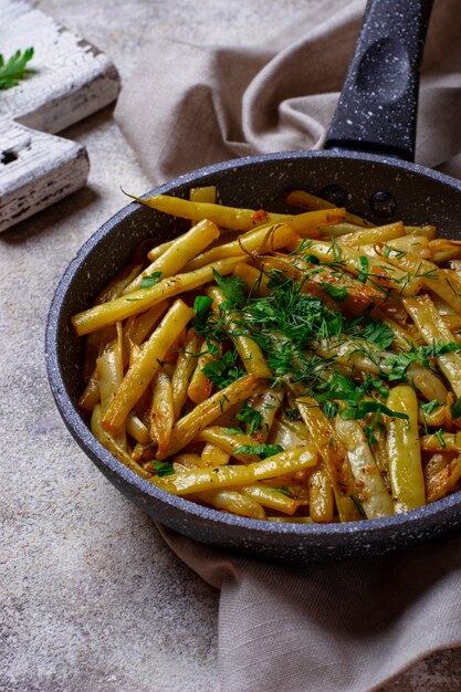 Stewed yellow wax beans in pan