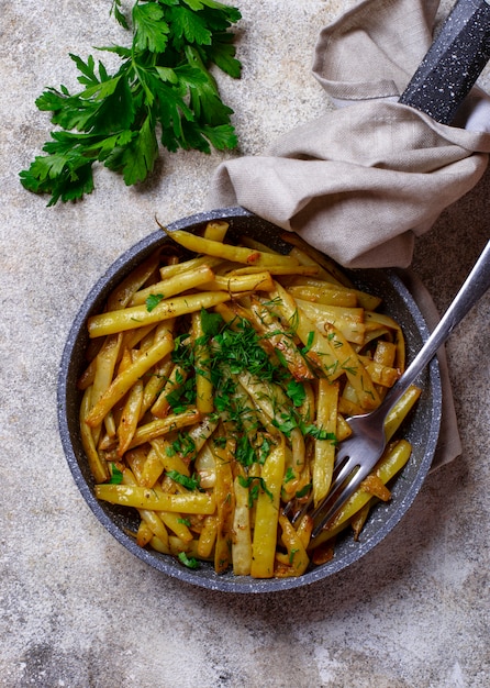 Stewed yellow wax beans in pan