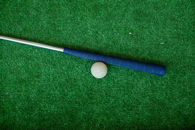 The stick lies on the field next to the hole stick lying near
golf ball green golf sport t