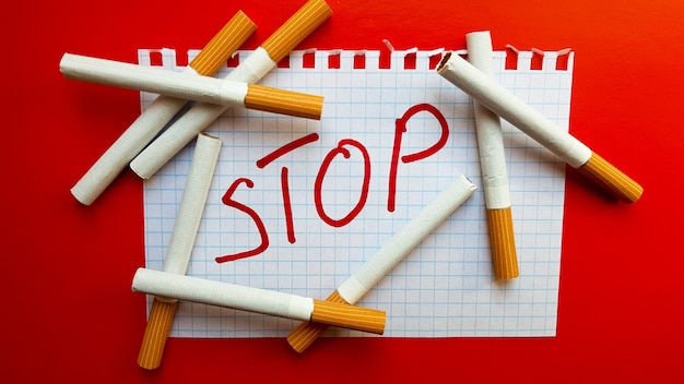 A sticker that says Stop is in a pack of cigarettes. World No Tobacco Day. Quit smoking. Fight with cigarettes.