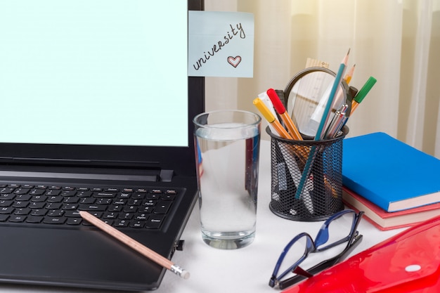 Photo sticker with word university. background - home table student