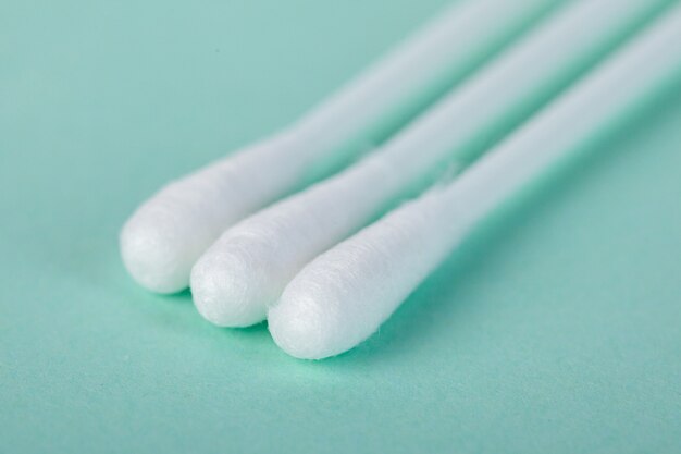 Photo sticks for cleaning ears on a green