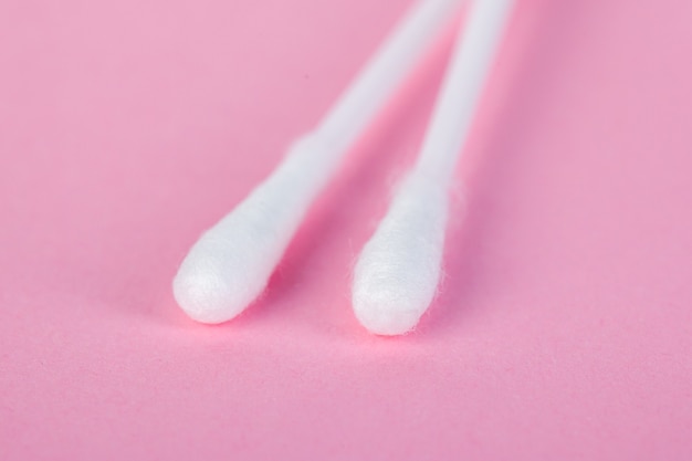 Sticks for cleaning ears on a pink 